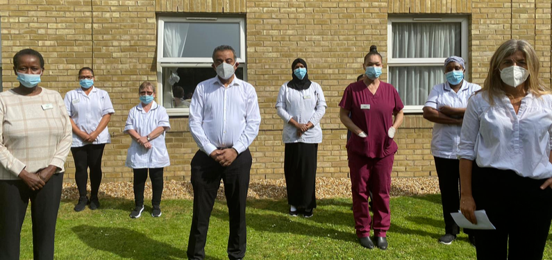 Socially distanced protest with healthcare workers wearing masks