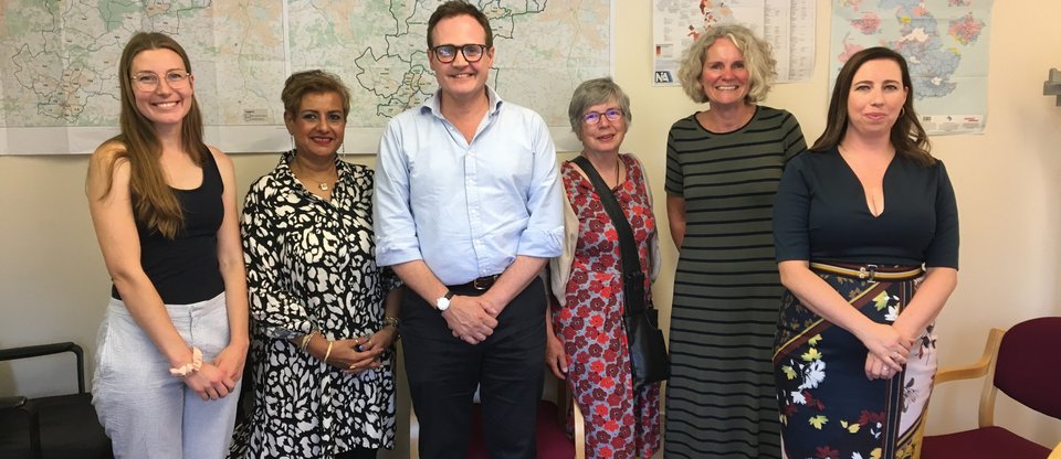 Leaders from the Settle Our Status campaign stand smiling with Tom Tugenhat, Tonbridge MP and Security Minister