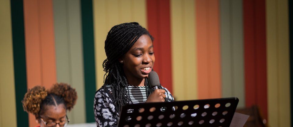 Young girl giving a speech at the Croydon Citizens Youth Assembly in 2019