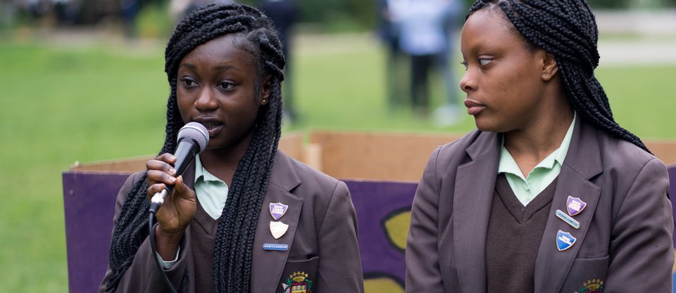 Two school pupils talking at an event about free school meals for children of parents with no resource to public funds