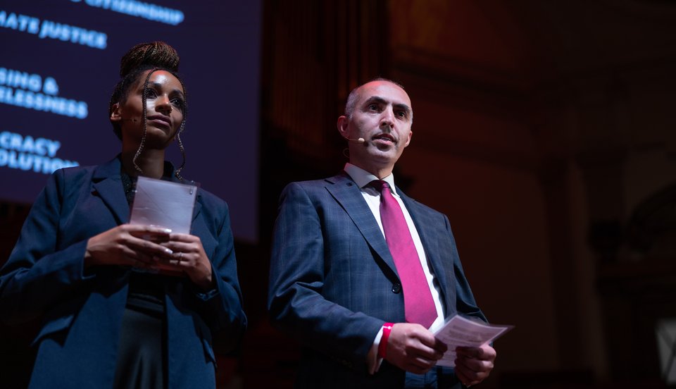 A Citizens UK leader sharing a testimony at a Citizens UK assembly