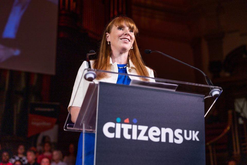 Angela Rayner speaking on stage at a Citizens UK assembly