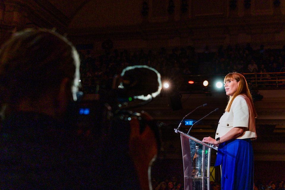 Angela Rayner on stage, speaking at a Citizens UK assembly.