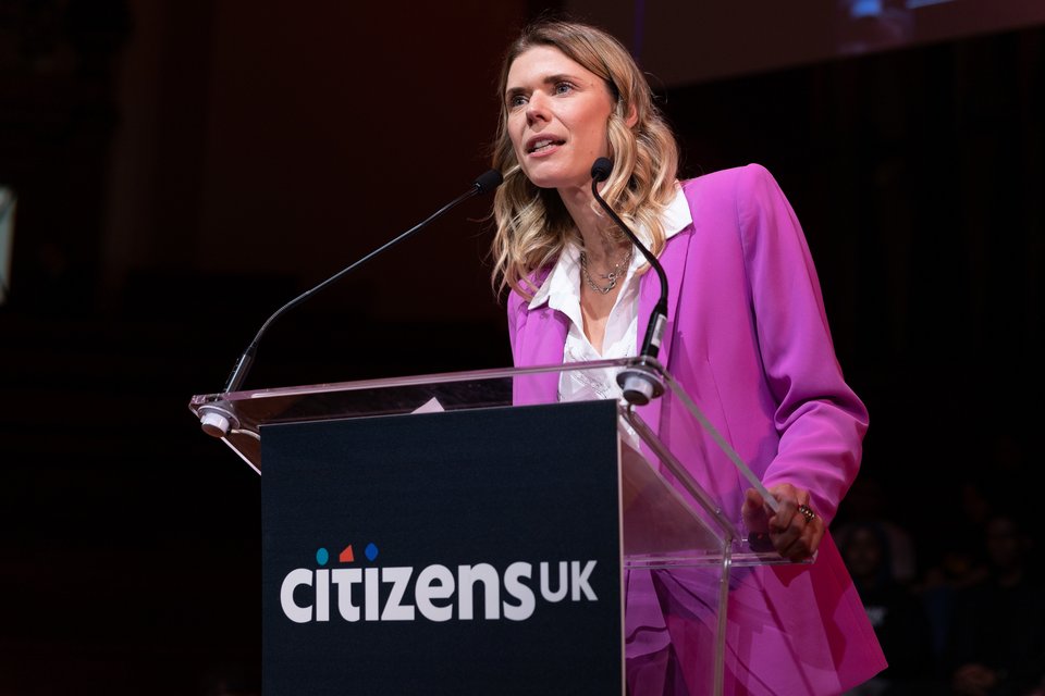 Sarah Gezdari on stage at a Citizens UK Assembly