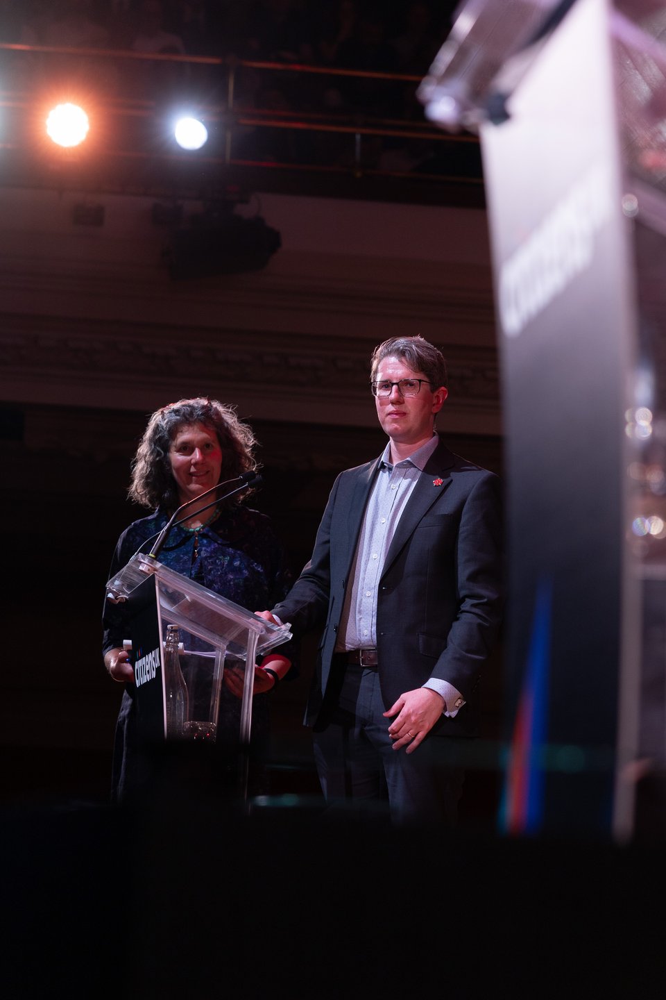 A Citizens UK leader is submitting a campaign ask to an electoral candidate on stage