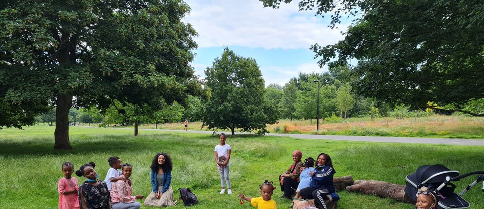 Mums and children relaxing together in a park