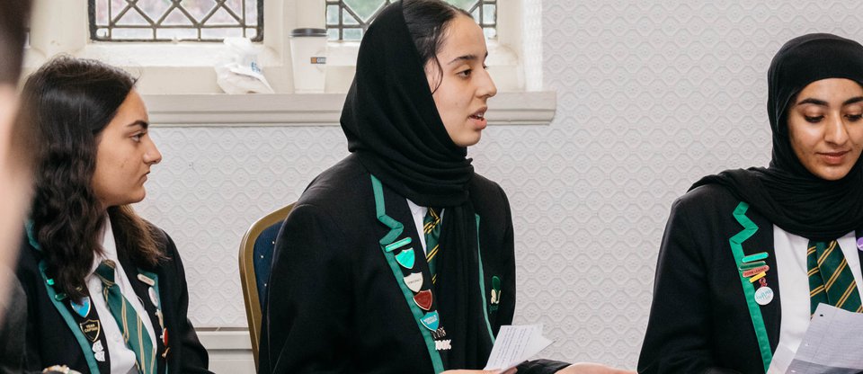 School girls speaking in academic report meeting