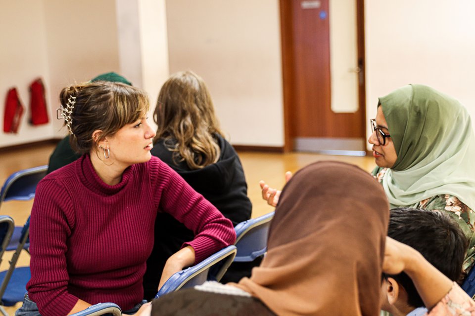 Two women sitting on chairs having a conversation