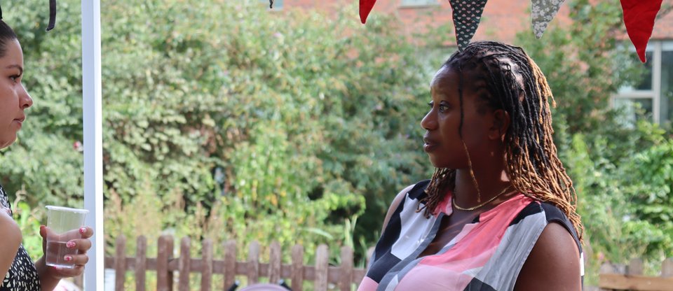 Two mothers are in conversation at a Parent Action celebration event.