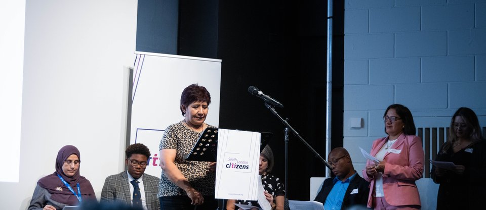 Woman speaking at podium during south london listens assembly