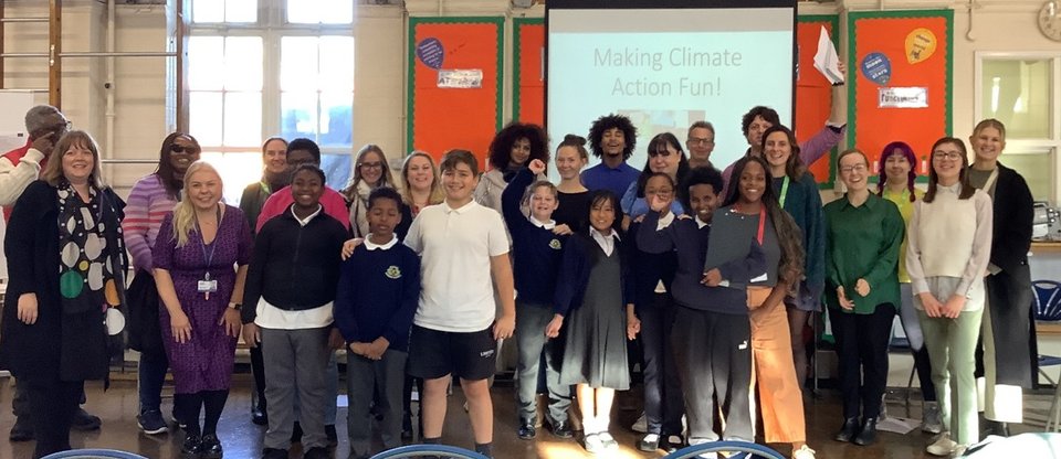A group of pupils and community leaders celebrate the success of their climate action.