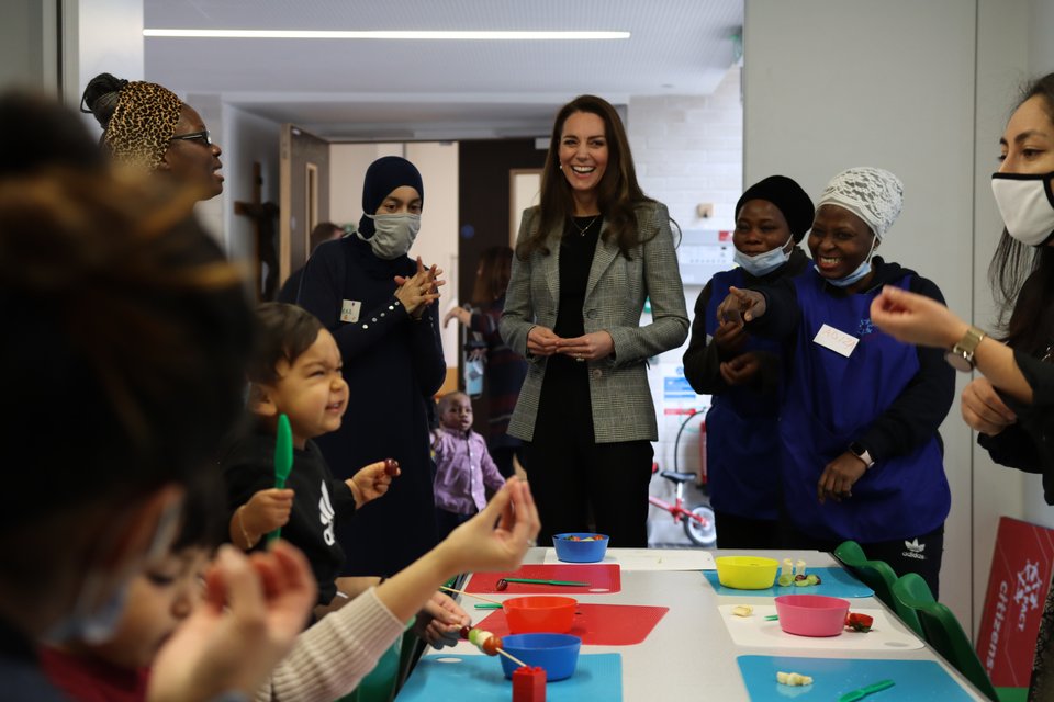 Duchess of Cambridge, Kate Middleton, at a Parents and Communites Together (PACT) Southwark event smiling with children and workers