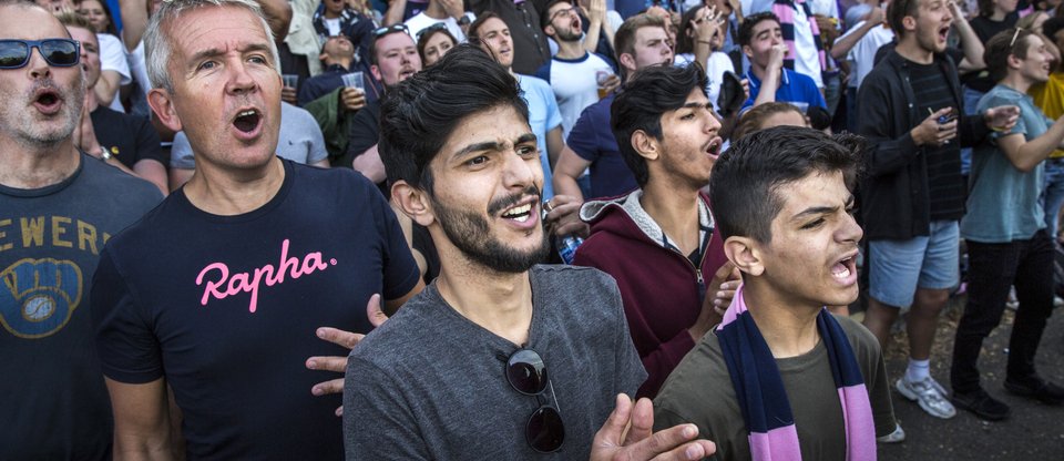 Resettled refugees go to watch a football match