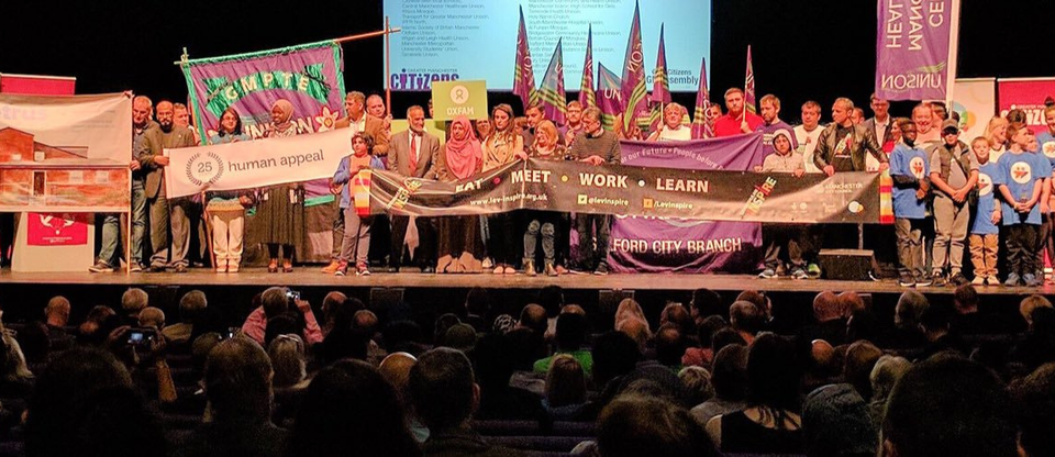 GMC Leaders at the founding assembly, holding banners and signs