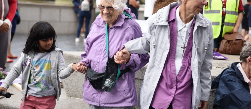 Young girl helping elderly residents in London bridge