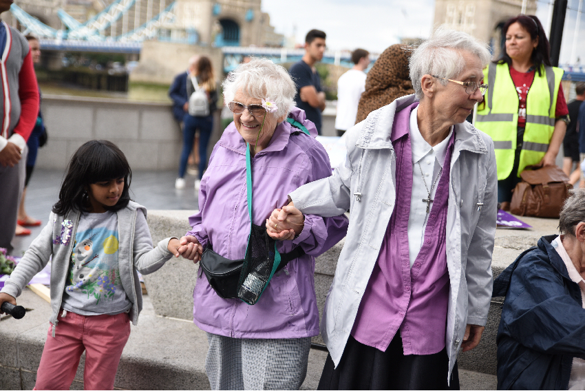 Young girl helping elderly residents in London bridge