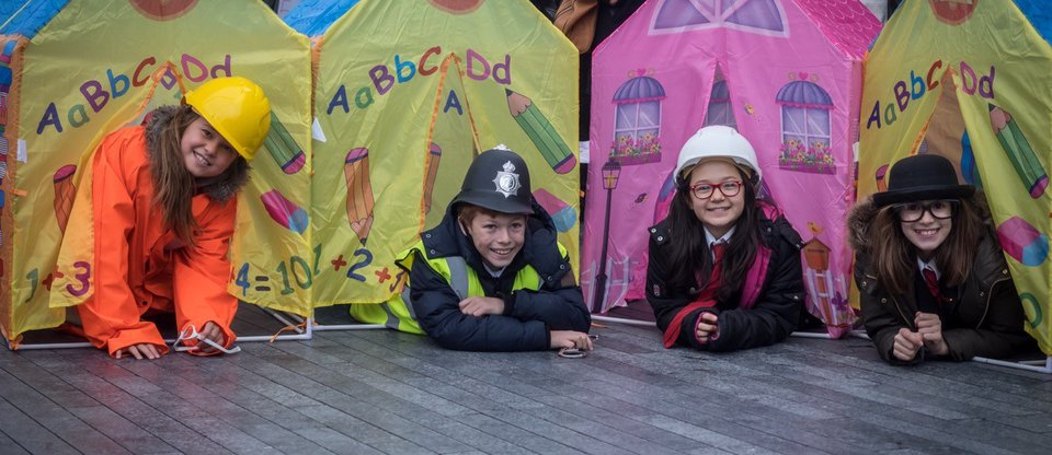 Children smiling outside tents