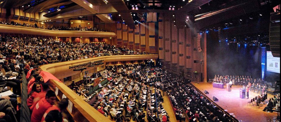 Packed hall looking towards a stage