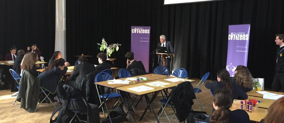 Local school children, from a Merton member institution, are gathered in a hall to celebrate the Merton Citizens mental health campaign