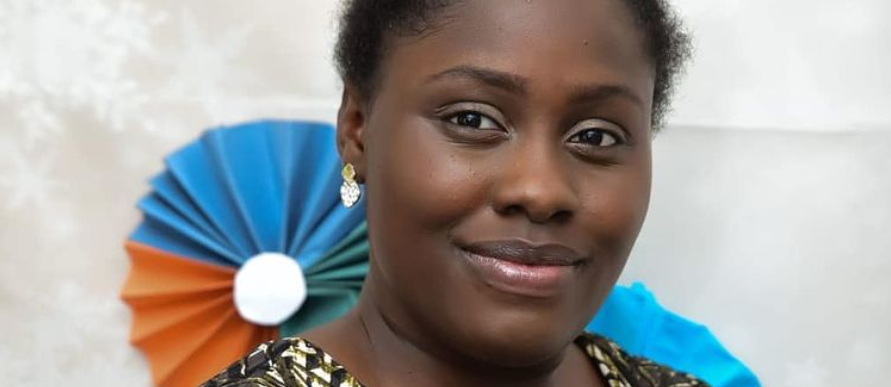 Headshot portrait of woman smiling and looking to camera