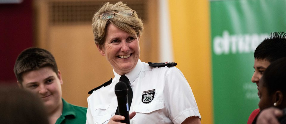 Female police representative smiling during speech