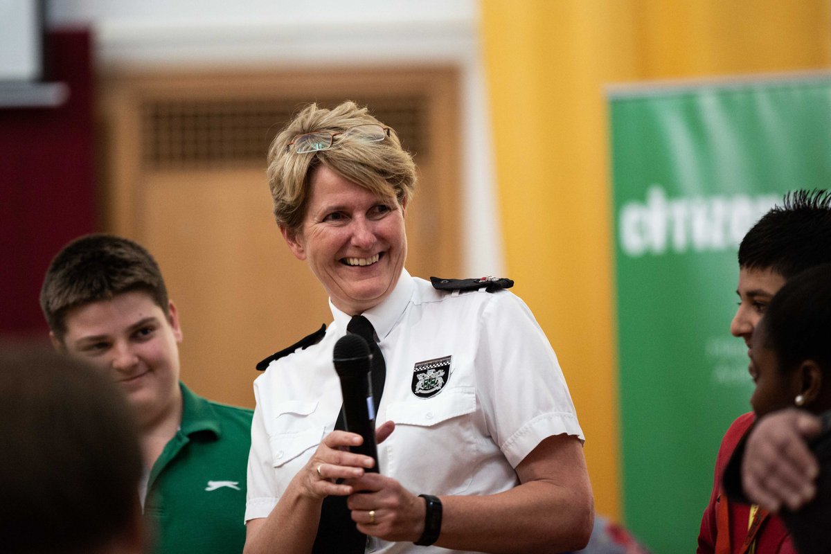 Female police representative smiling during speech