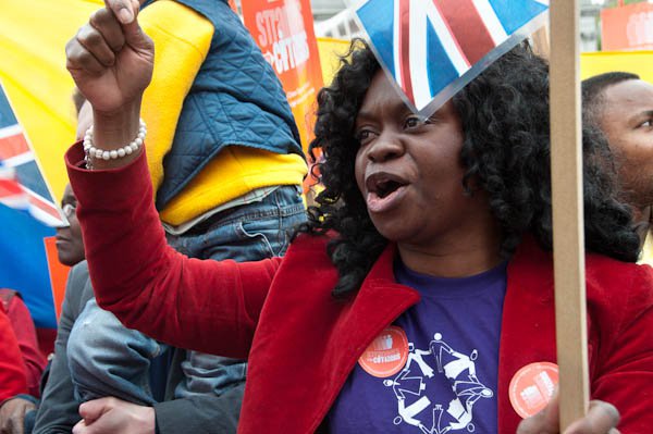 Woman protesting for "Strangers into Citizens"