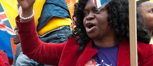 Woman protesting for "Strangers into Citizens"